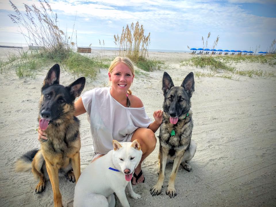 Paw & Order owner, owner, on the beach with 3 of her dogs